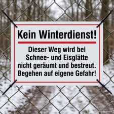Das Bild zeigt ein Schild, das auf einem Zaun befestigt ist und darauf hinweist, dass der Weg im Winter bei Schnee und Eis nicht geräumt oder gestreut wird. Es warnt die Passanten, dass sie diesen Weg auf eigene Gefahr betreten.