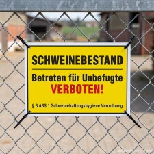 Das Bild zeigt ein gelbes Schild, das an einem Zaun...