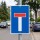 Das Bild zeigt ein Verkehrsschild, das eine Sackgasse anzeigt. Es hat einen blauen Hintergrund mit einem großen weißen T in der Mitte, das oben von einem roten Balken gekrönt wird, und steht an einer Straße, wo Fahrzeuge nicht weiterfahren können.