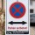 Das Bild zeigt ein Schild mit der Aufschrift Parken verboten! in großen, roten Buchstaben auf weißem Hintergrund. Darüber befindet sich ein roter Kreis mit einem blauen X, das symbolisiert, dass das Parken in diesem Bereich nicht gestattet ist, und es wird darauf hingewiesen, dass Fahrzeuge auf Kosten des Halters abgeschleppt werden können.