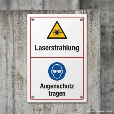 Das Bild zeigt ein Warnschild, das auf die Gefahr von Laserstrahlung hinweist. Oben befindet sich ein gelbes Dreieck mit einem Symbol für Laser, und darunter steht in großen Buchstaben „Augenschutz tragen“ auf einem blauen Hintergrund, was darauf hinweist, dass beim Arbeiten in diesem Bereich Schutzbrillen getragen werden müssen.